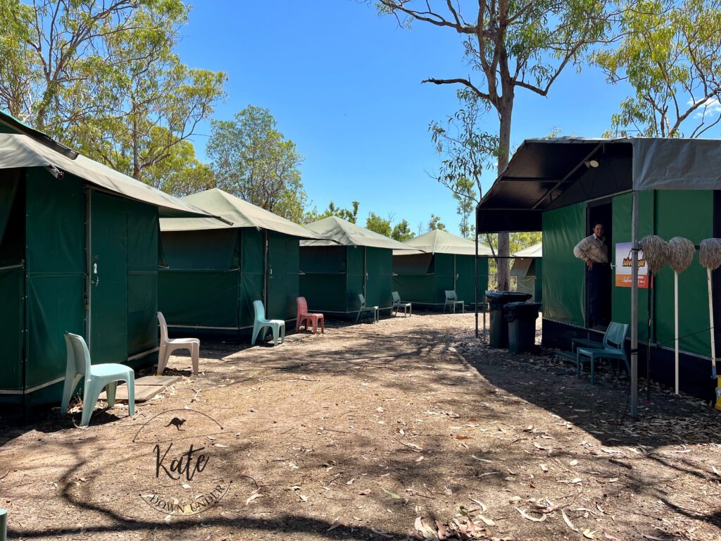 Our camp for nights 1 and 2. Sleeping shelters on the left, kitchen/dining shelter on the right with our tour guide.