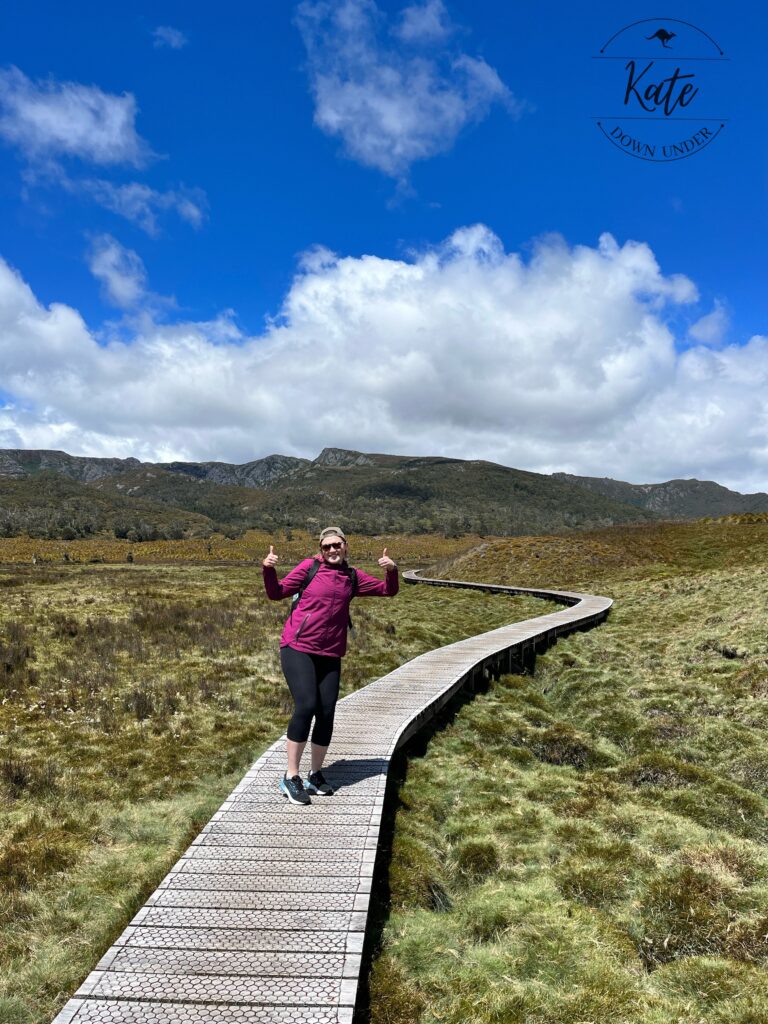 Kate at the beginning of the hike, wearing her rain jacket and giving the thumbs up to signal she's ready to go