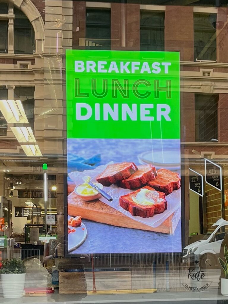 A digital billboard with images of banana bread and the caption "breakfast lunch dinner"