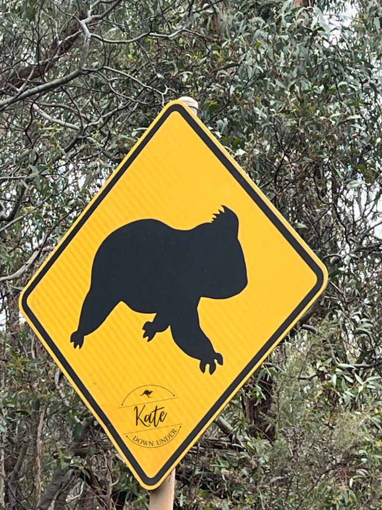 A beware of crossing koalas sign, with the koala silhouette having three legs