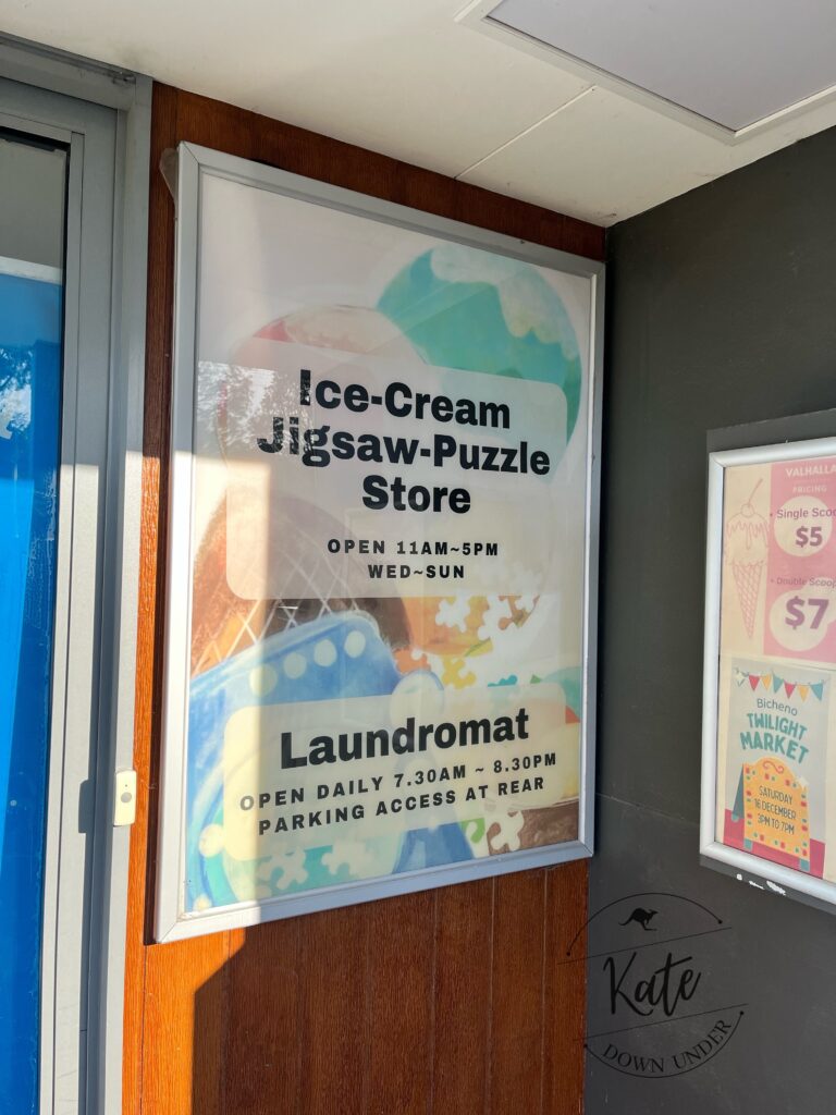 a sign outside of a shop that reads 'ice-cream jigsaw-puzzle store'