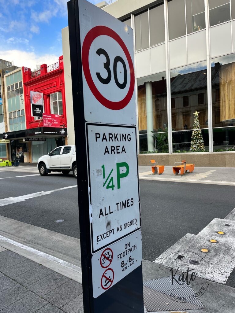 road signs that read 30, parking area 1/4 P all times