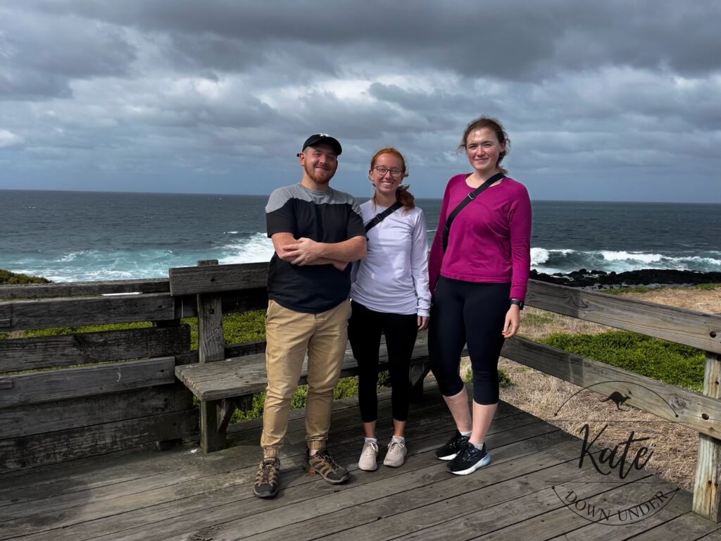 Lucas, Sydney, and Kate at the Nobbies Centre boardwalk on Phillip Island with Bass Strait in the background